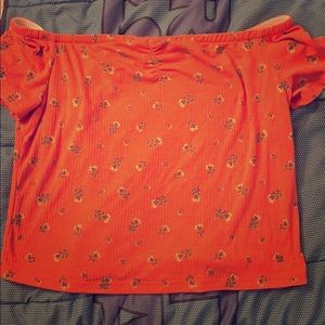 Cropped shirt that is off the shoulder.